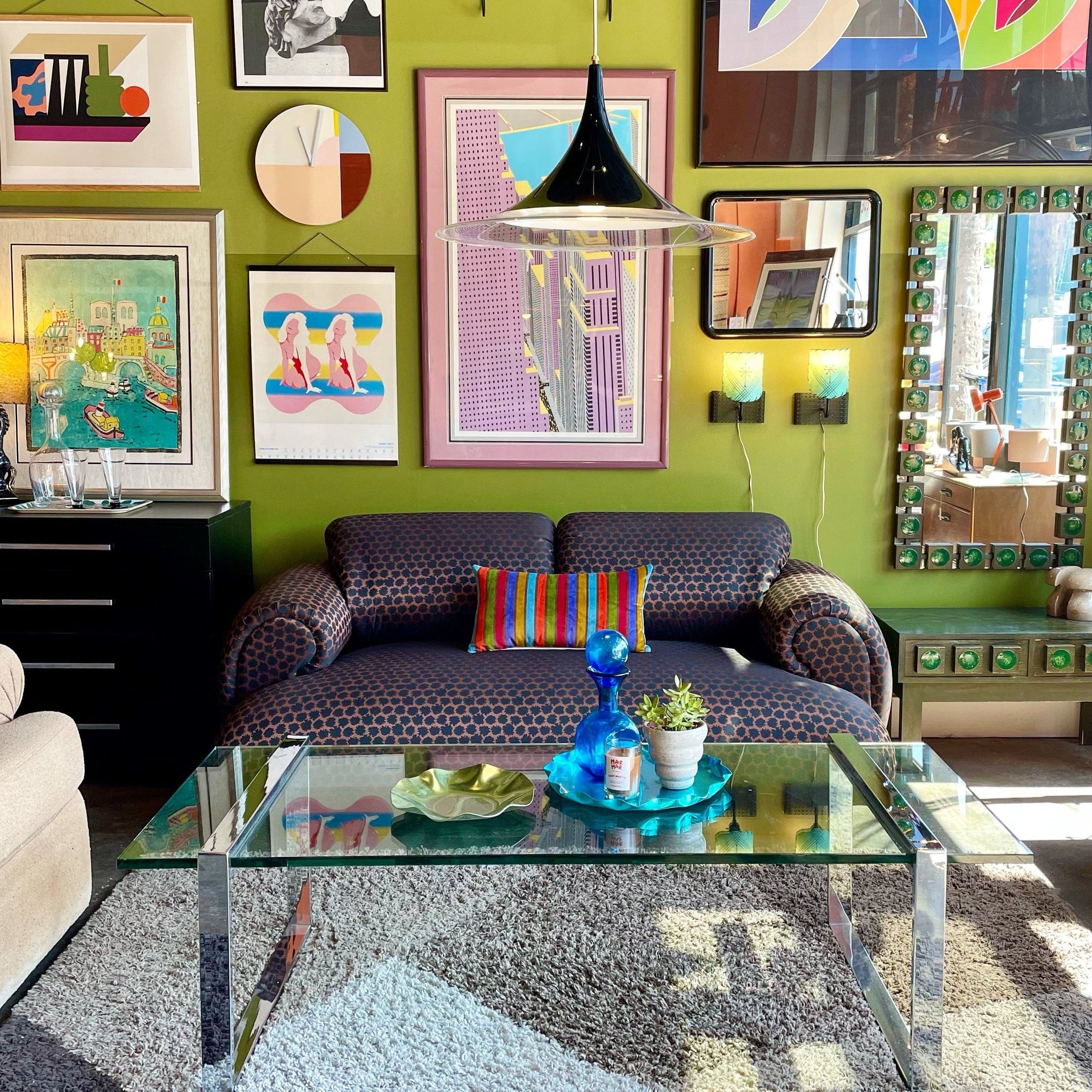 colorful designed room with art on the walls and a brown sofa