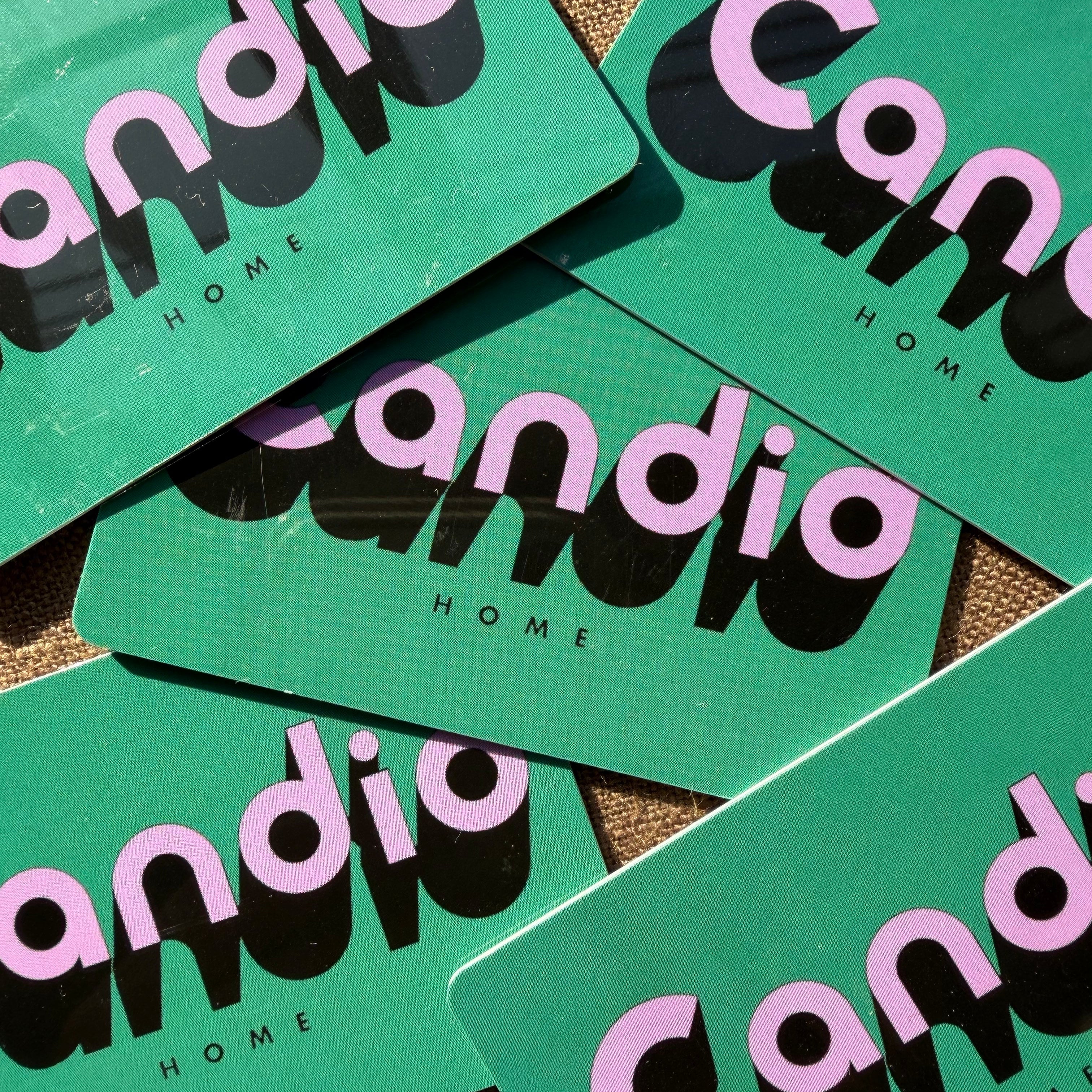 Green gift cards with 'candid home' branding on a textured surface