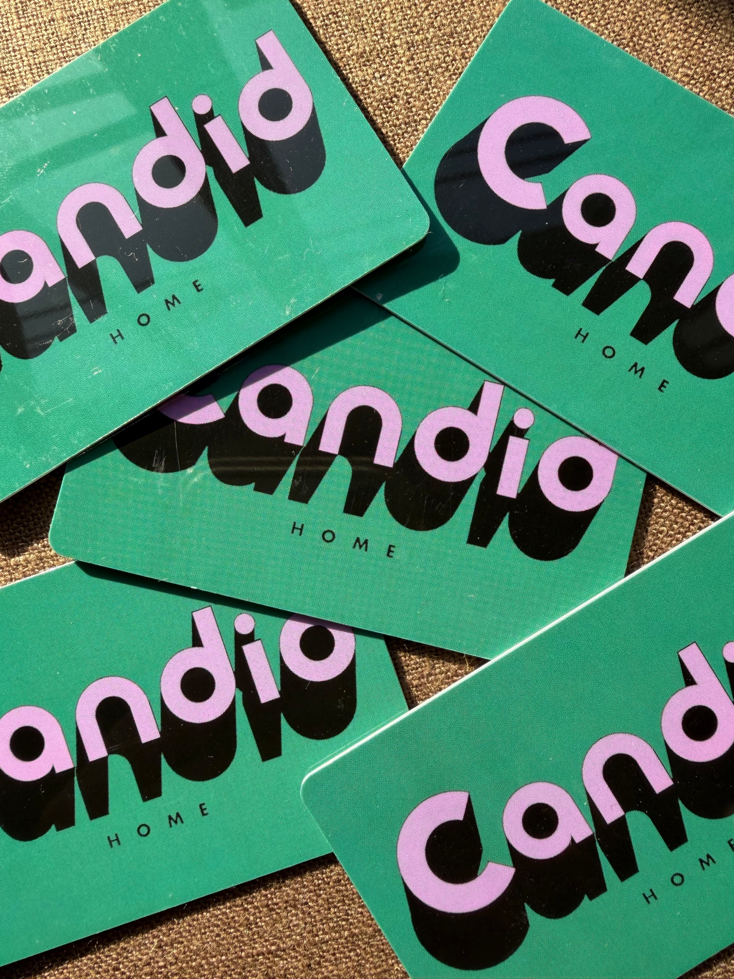 Green gift cards with 'candid home' branding on a textured surface